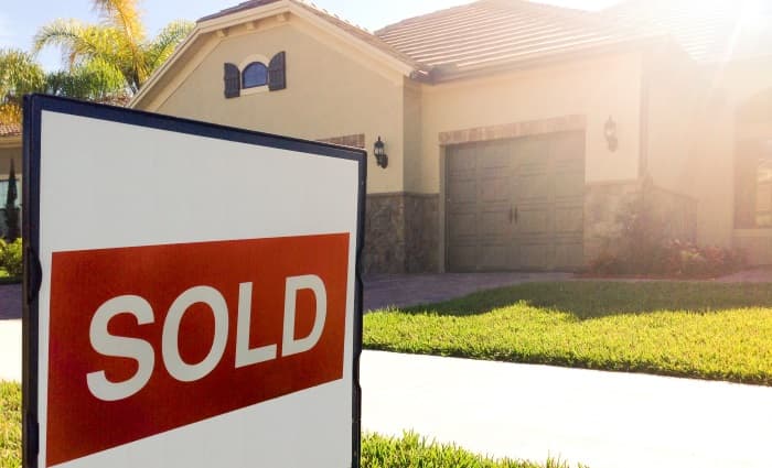 Home with Sold sign in front yard